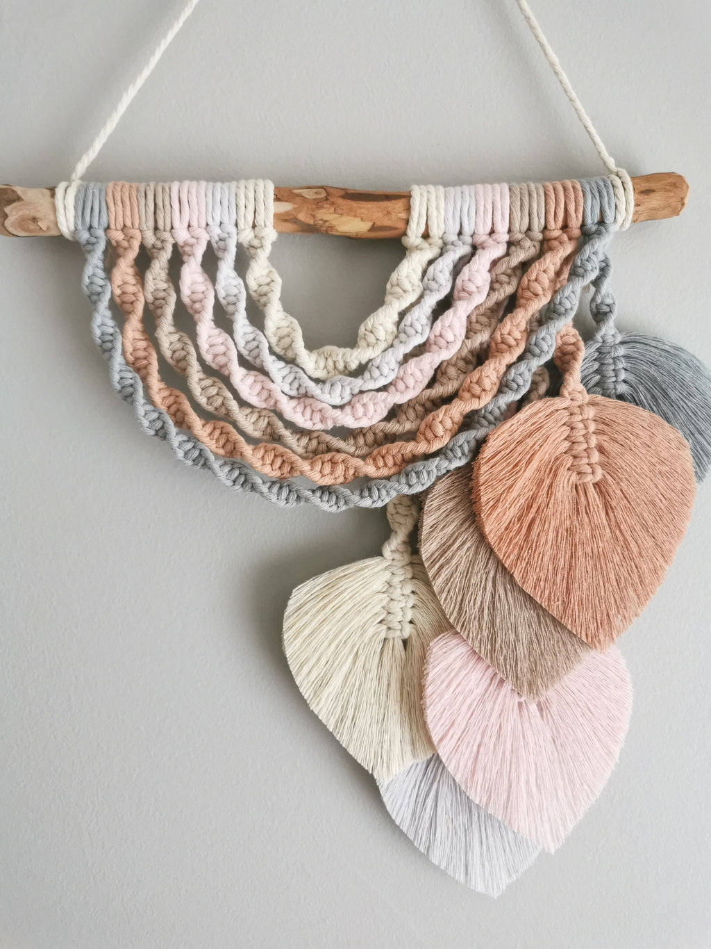 macrame rainbow with feathers in pastels colours, bohemian nursery decor